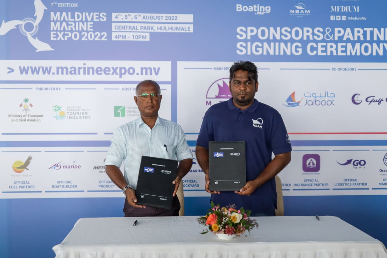 ޖުލައި 6، 2022: މެރިން އެކްސްޕޯގެ އޮފިޝަލް ބޯޓް ބިލްޑަރުގެ އެއްބަސްވުމުގައި އަލްޝާލީ މެރިން އިން ސޮއިކުރުމަށް ފަހު، މީޑިއަމް ޕްރައިވެޓްގެ މެނޭޖިން ޑިރެކްޓަރު ޝާމް މުހައްމަދުއެކު ފޮޓޯއަކަށް ހުއްޓިގެން -- ފޮޓޯ: މުހައްމަދު ޝާބިން/ އަދަދު