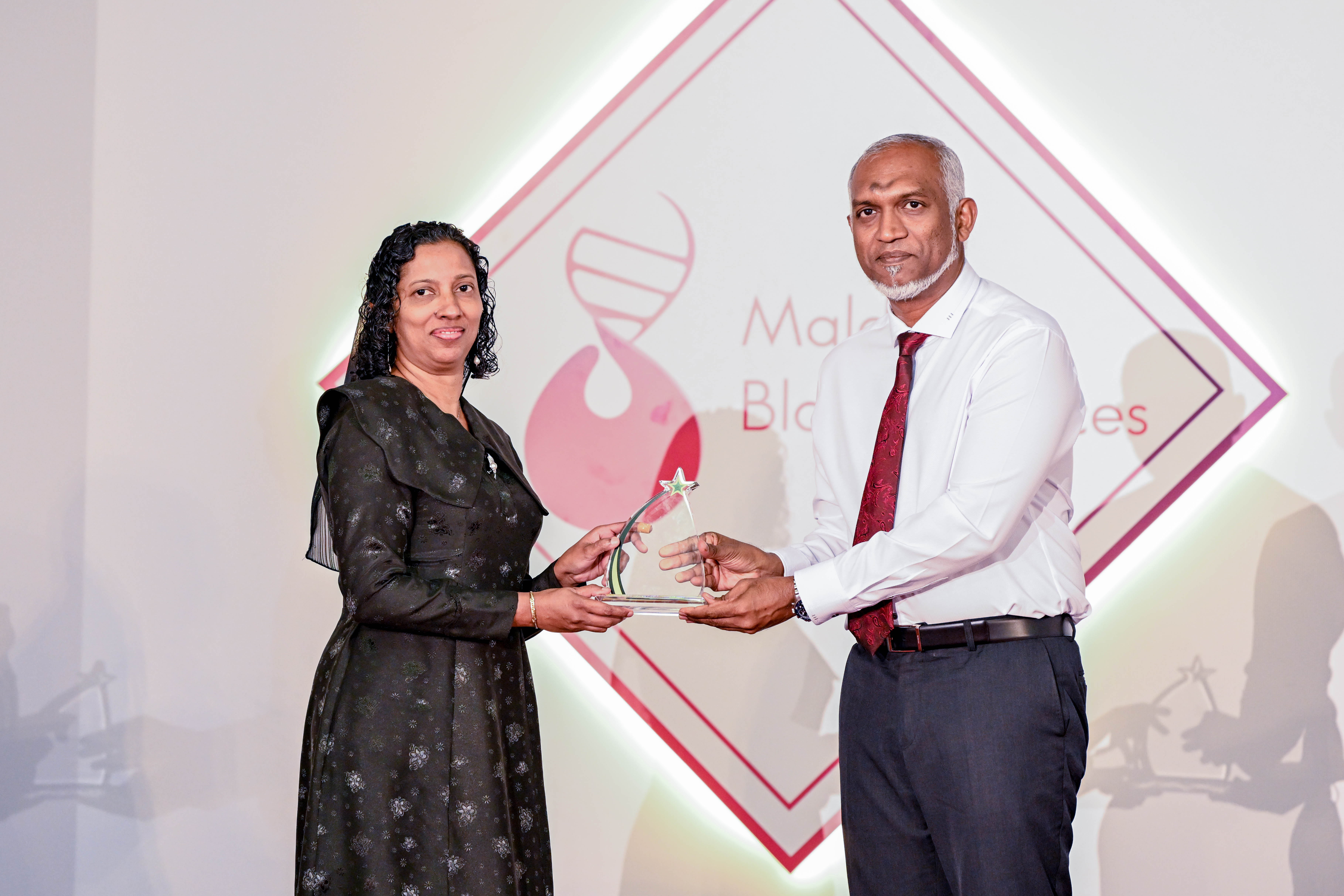 މެއި 8، 2024: ބައިނަލްއަގުވާމީ ތެލަސީމިއާ ދުވަސް ފާހަގަކުރުމަށް މިރޭ ސޯޝަލް ސެންޓަރުގައި ބޭއްވި ރަސްމިއްޔާތުގައި އެ ދާއިރާގައި ހިދުމަތް ކުރެއްވި ފަރާތަކަށް ރައީސް ޑރ. މުހައްމަދު މުއިއްޒު ހަނދާނީ ފިލާ ހަވާލުކޮށް ދެއްވަނީ. -- ފޮޓޯ: ރައީސް އޮފީސް