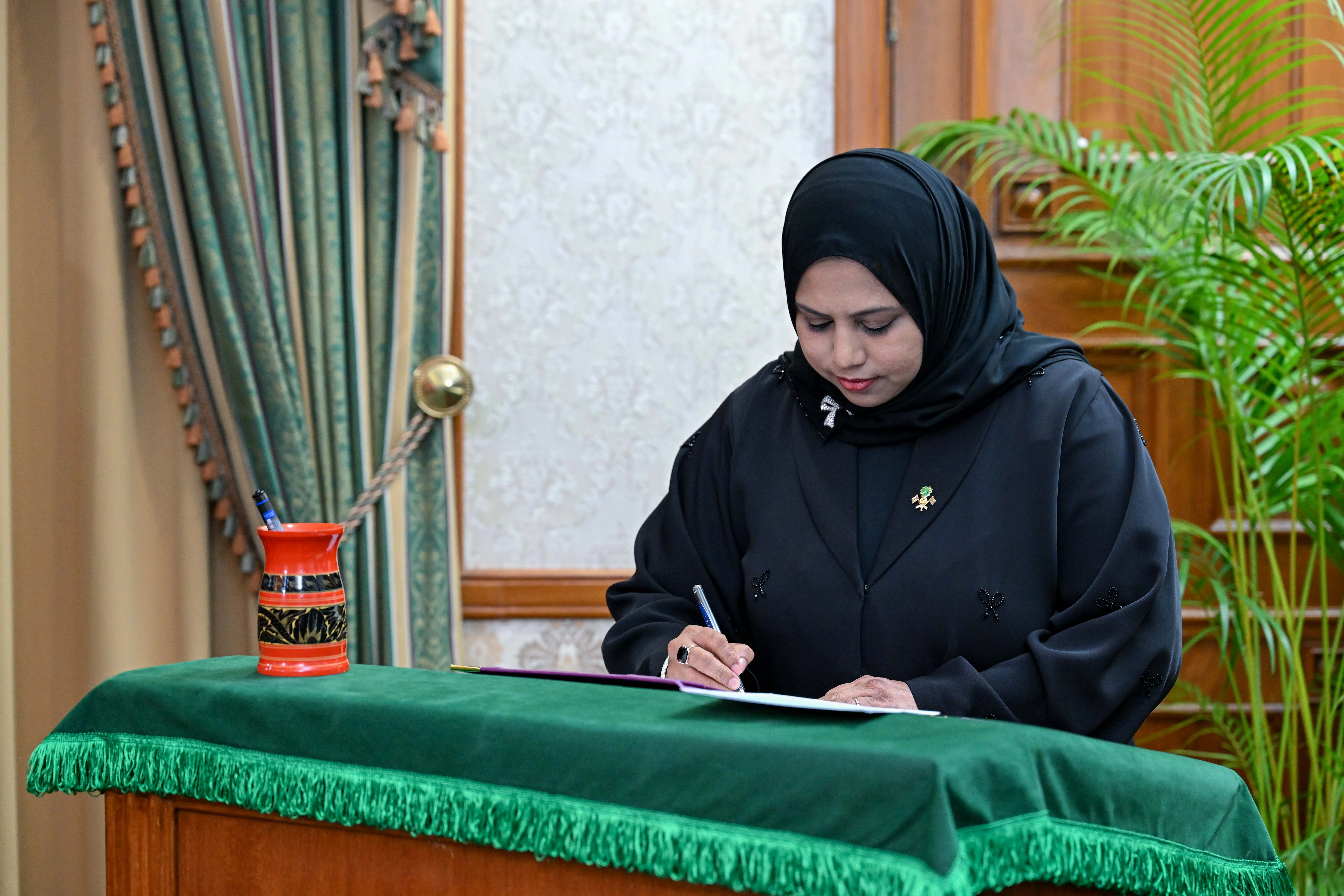 Minister of Arts, Culture and Heritage, Her Excellency Heena Waleed, signs her official letter of appointment.