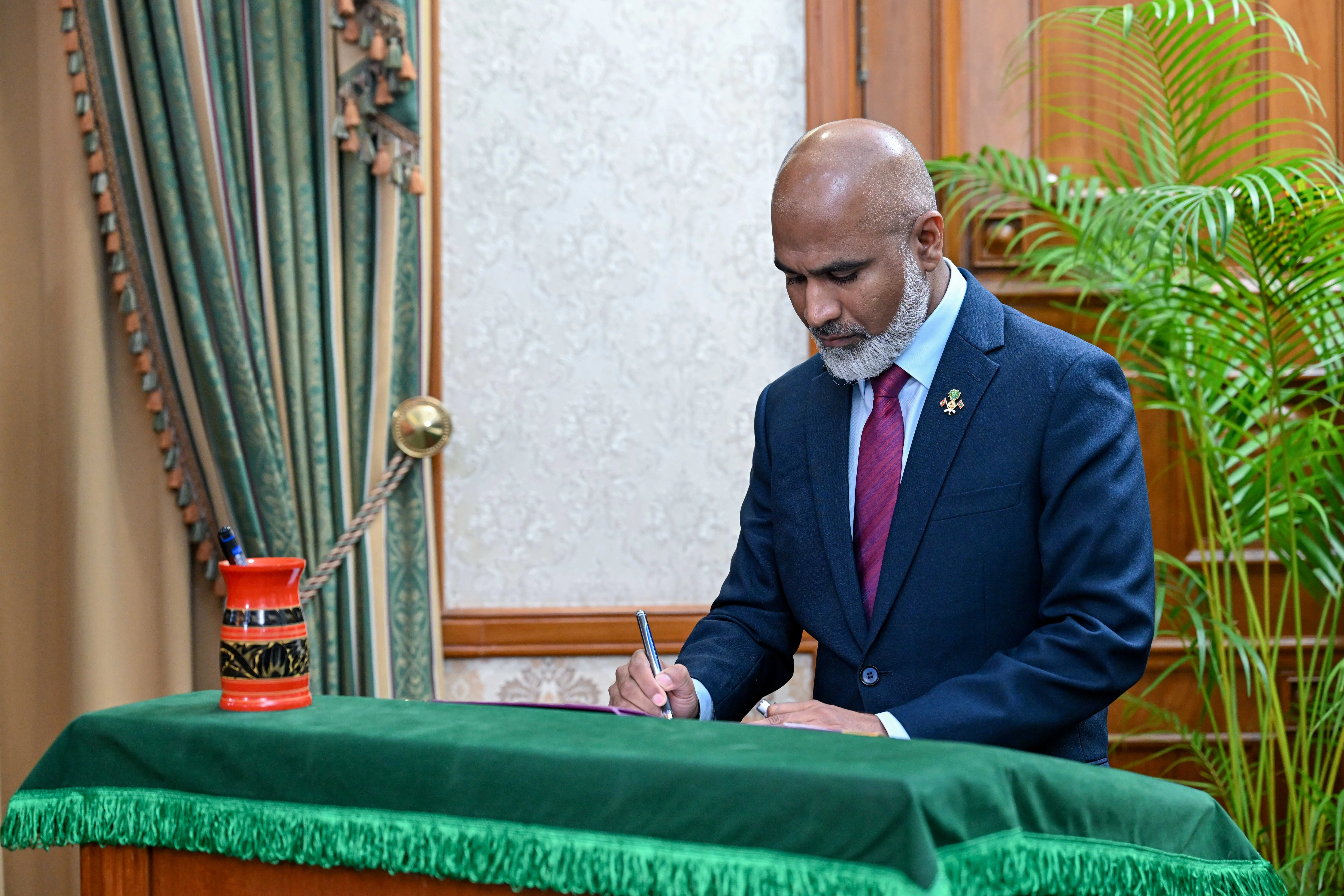 Minister of Education, Higher Education, and Skills Development Dr. Ismail Shafeeu signs the instrument of appointment.